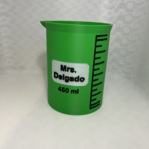Green 3D printed laboratory beaker pen holder with a name label and 450 ml marking