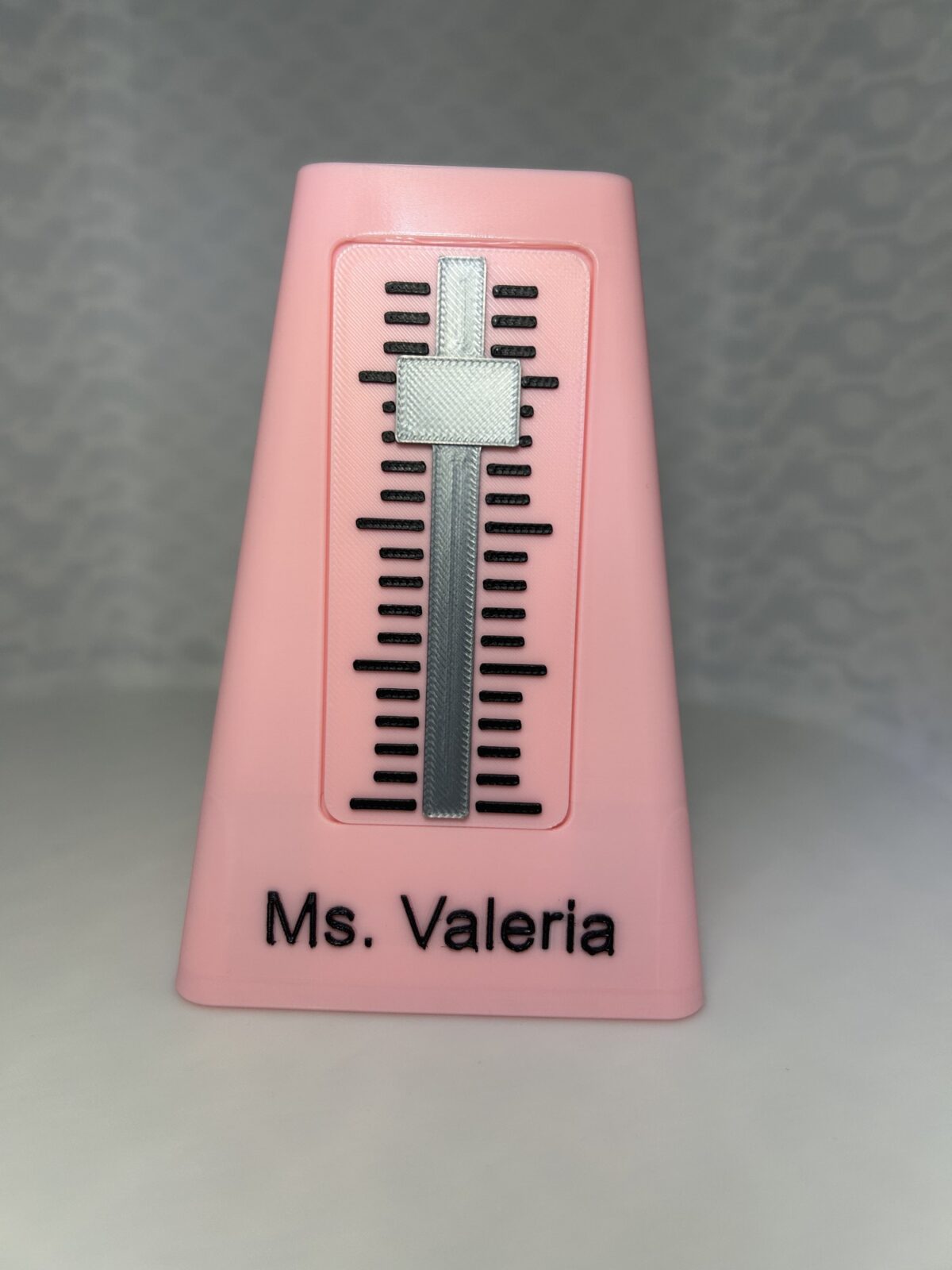 Pink 3D printed metronome pen holder personalised with the name Ms. Valeria